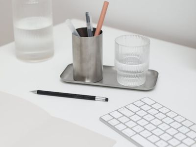 A glass of clean water next to exercise equipment.