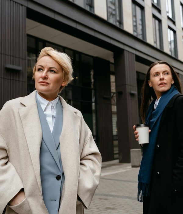 Person in a dynamic pose in a minimalist, spacious room.